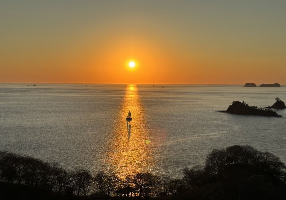 Sailboat on calm water at sunset