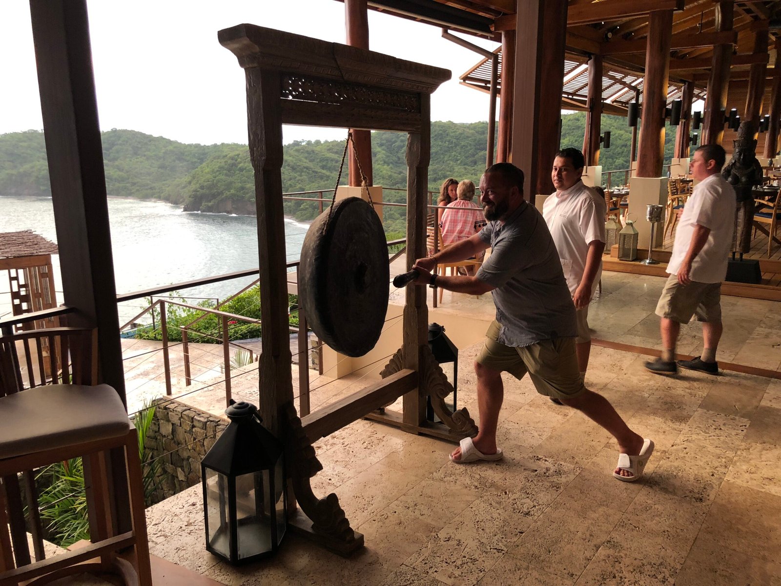 Ringing the sunset gong at Sentido Norte restaurant Casa Chameleon Las Catalinas Costa Rica
