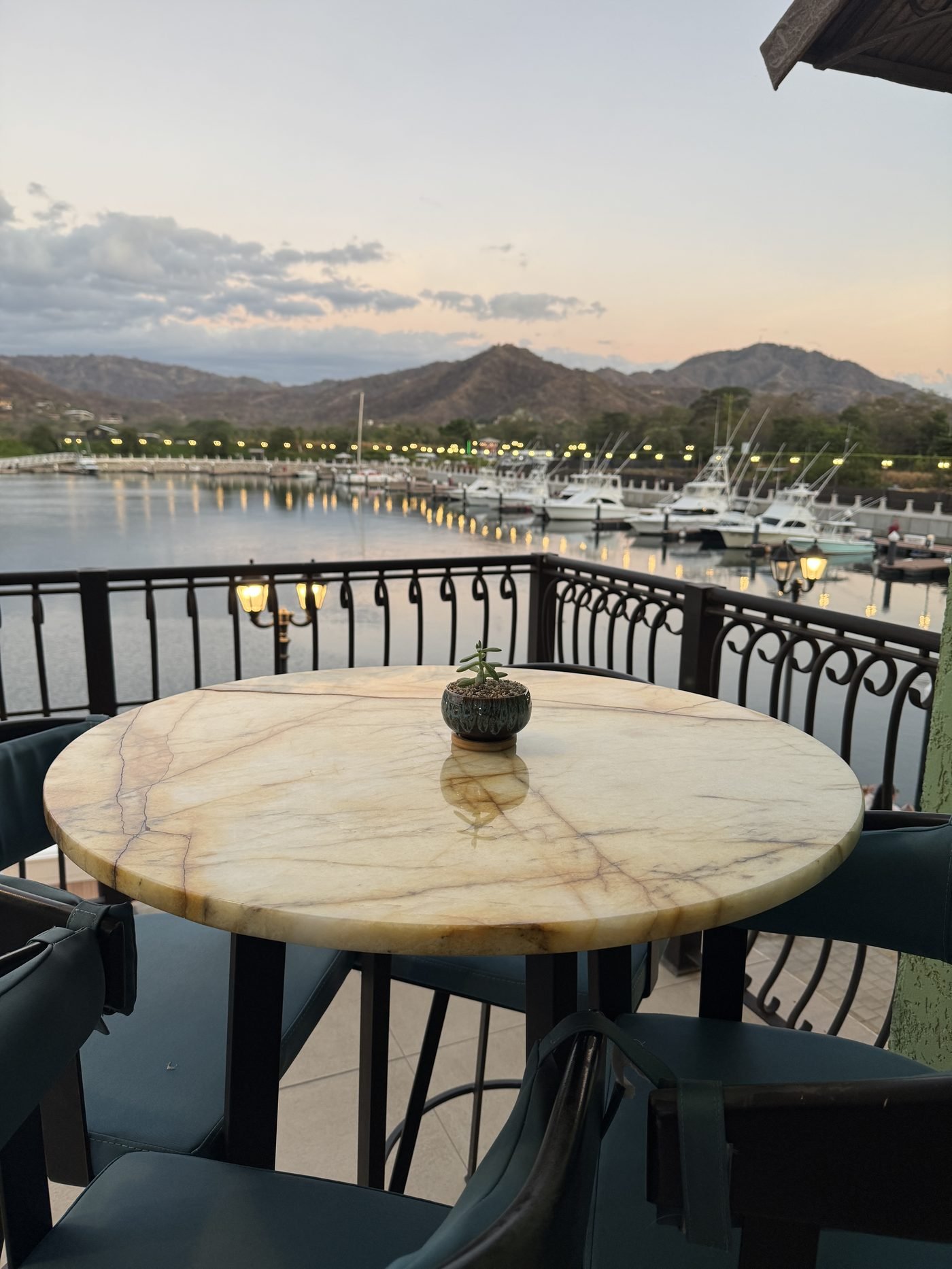 Private villa terrace dining table overlooking Marina Flamingo at sunset, Costa Rica