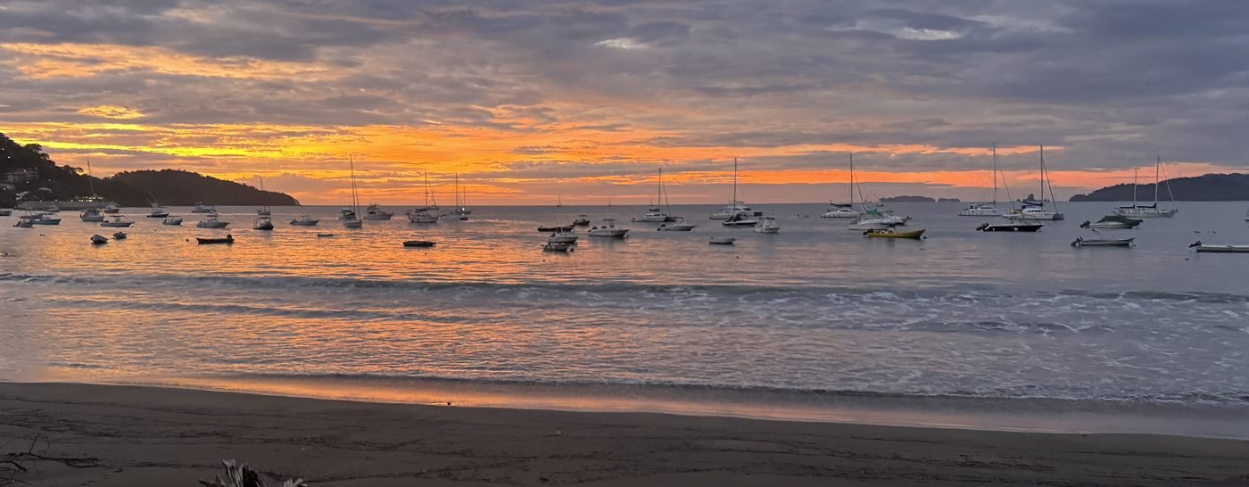 Fishing boats and sailboats anchored in a Guanacaste bay at sunset on Costa Rica's Gold Coast