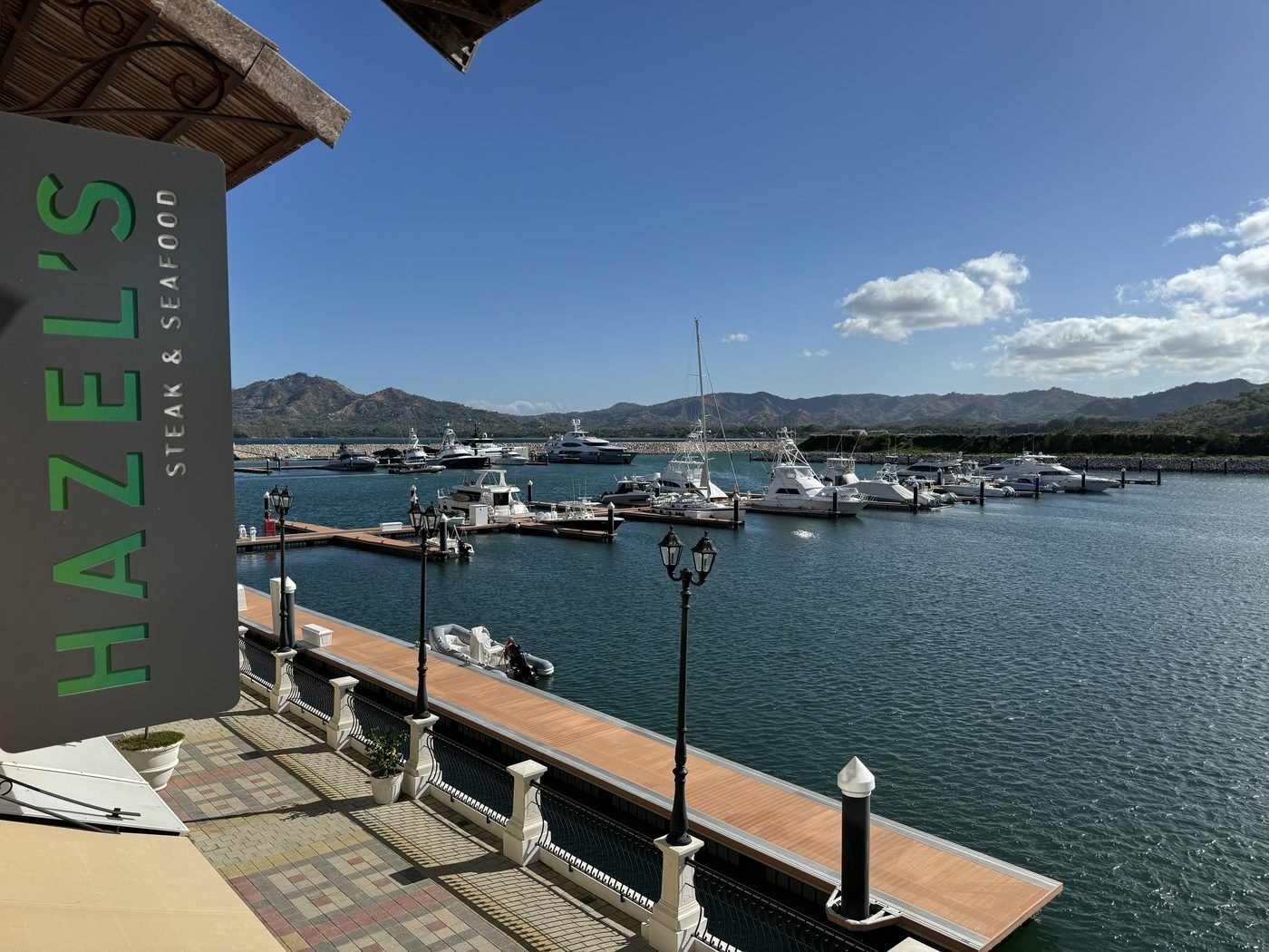 Hazel's Steak and Seafood restaurant sign above the boat slips and sportfishing yachts at Flamingo Marina Costa Rica