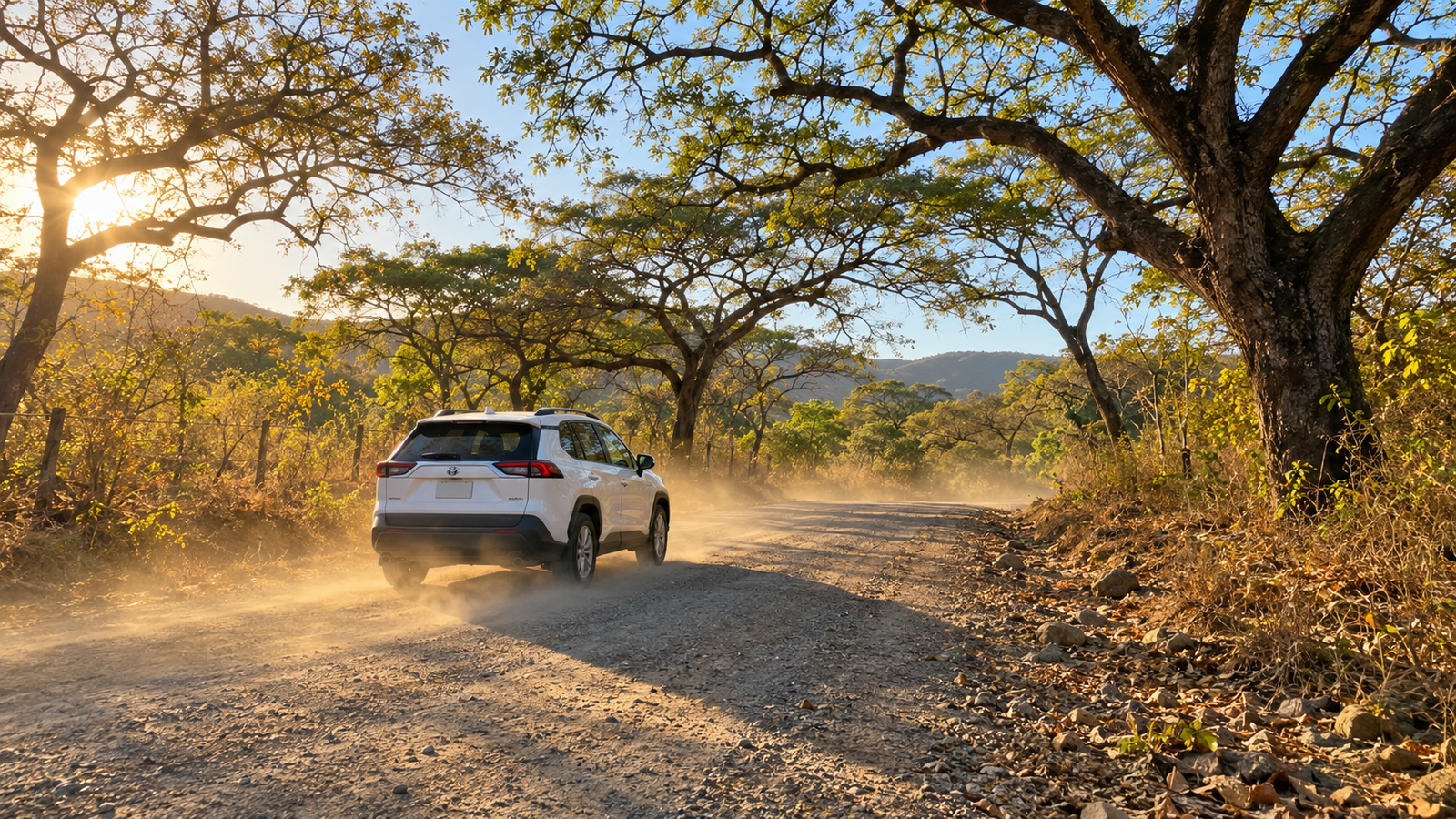 Rental SUV on a dusty gravel road through Guanacaste dry forest, the kind of side road where travelers ask if you need a 4x4 in Costa Rica