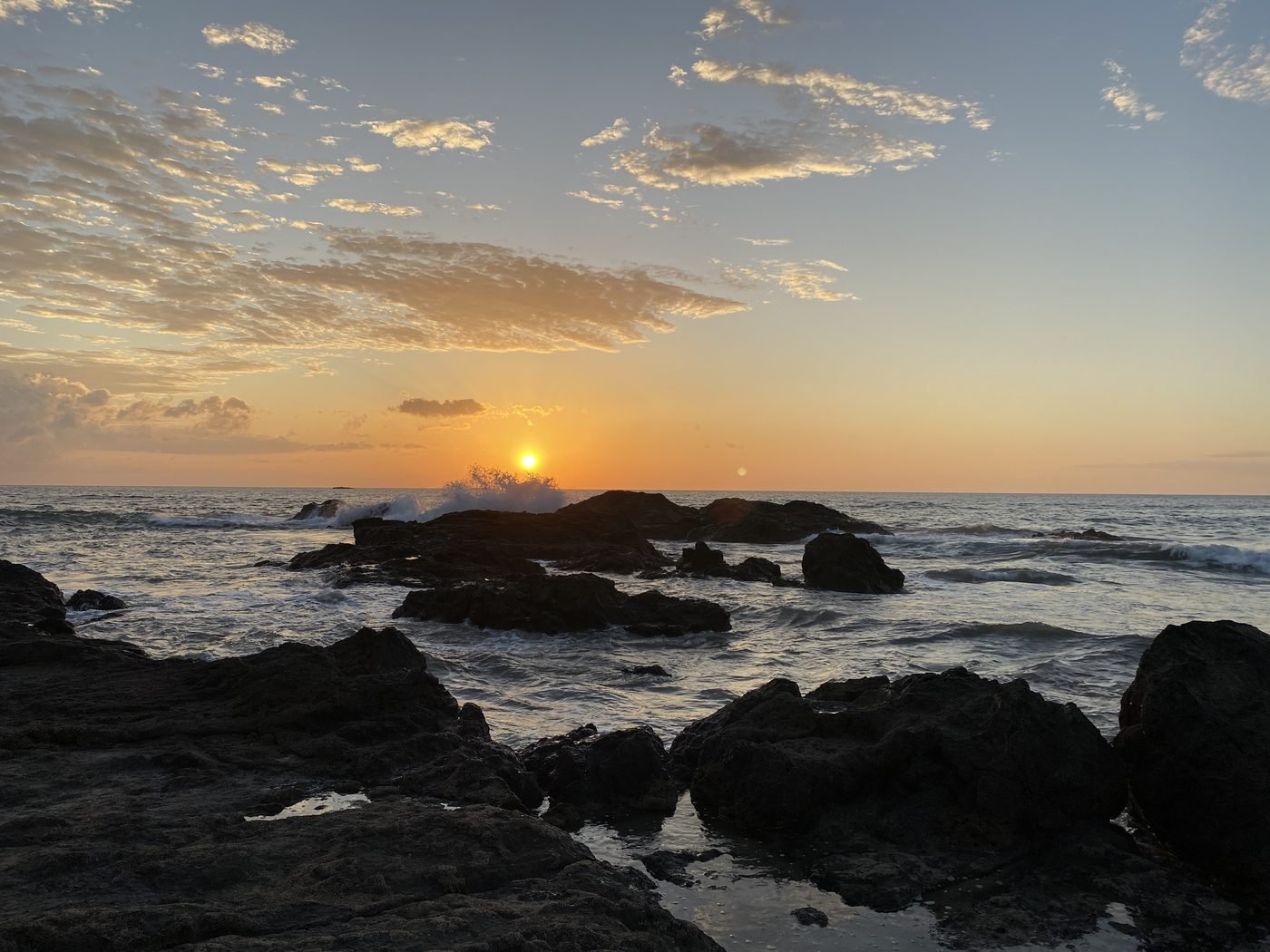 Mid December dry season sunset over the rocks at Playa Flamingo Guanacaste Costa Rica
